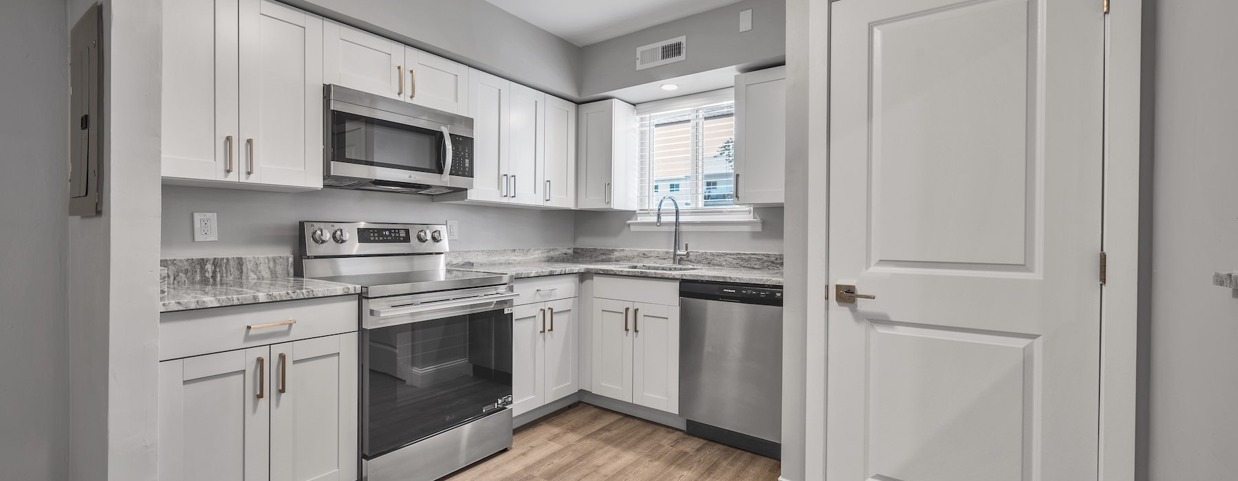 a kitchen with white cabinets