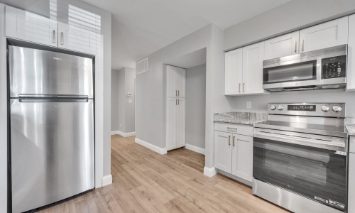 a kitchen with white cabinets