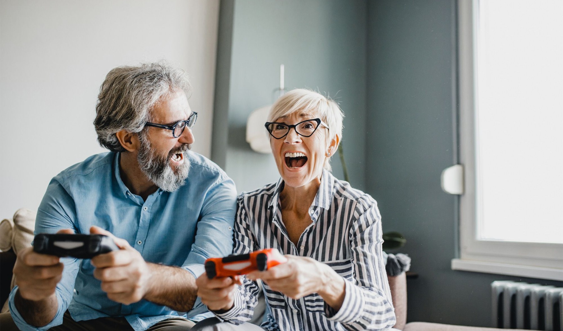 a man and a woman laughing playing video games